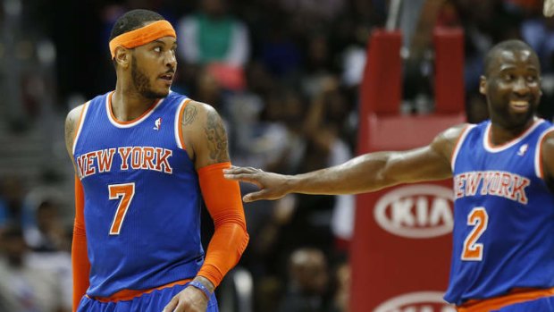 New York Knicks forward Carmelo Anthony is pushed away by teammate Raymond Felton after exchanging word with a Hawks player in Atlanta. Atlanta won 107-98.