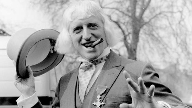 Fallen hero: Jimmy Savile sports his OBE after his investiture at Buckingham Palace in 1972.