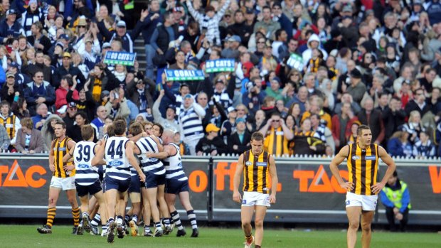 Geelong players celebrate Jimmy Bartel's point after the siren to win the game.