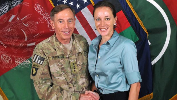 General Davis Petraeus, left, shaking hands with Paula Broadwell