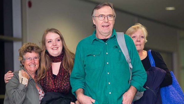 Colin Russell with his wife Christine (right) and daughter Madeleine (second from left) arriving at Hobart Airport.