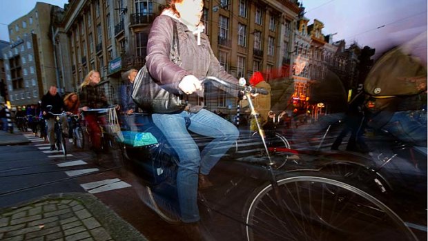 Commuters ride their bikes in late afternoon traffic in Amsterdam. Problems all-too familiar to car drivers the world over are now also threatening to turn the Dutch dream of bicycling bliss into a daily hell.