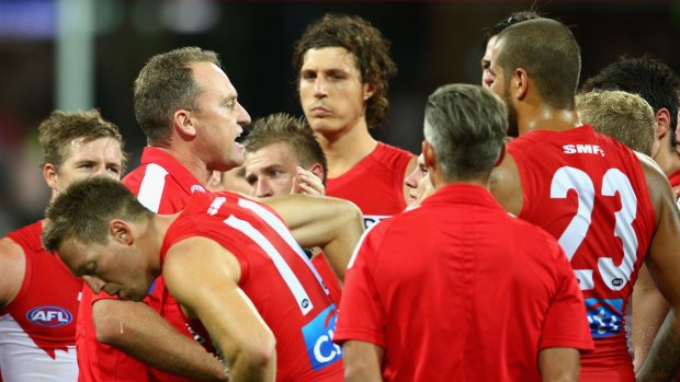 Come on boys: Swans coach John Longmire talks to his players during an interval.