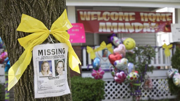 A missing person's poster for recently freed Amanda Berry appears in front of her sister's house in Ohio.