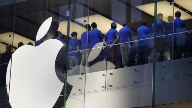 Ready for action ... staff at the Sydney Apple store hold a meeting before they open their doors.