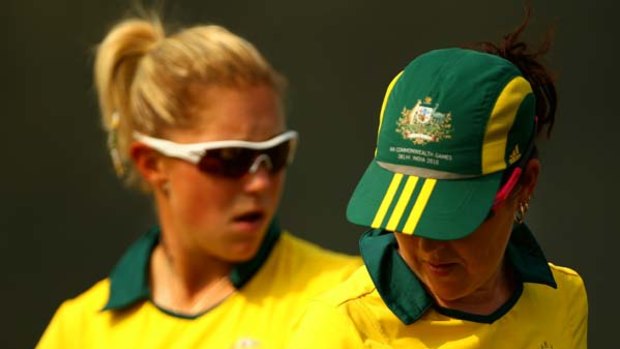 Natasha Van Eldik and Lynsey Armitage of Australia study the position of their bowls in their match against South Africa.