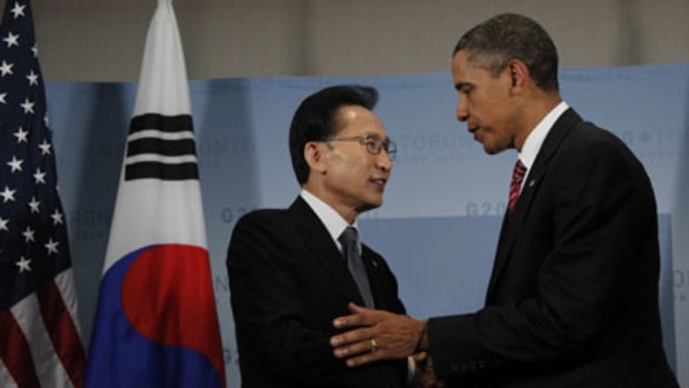 Signal to the North ... Lee Myung-bak, left, greets Barack Obama on the sidelines of the G20 summit.