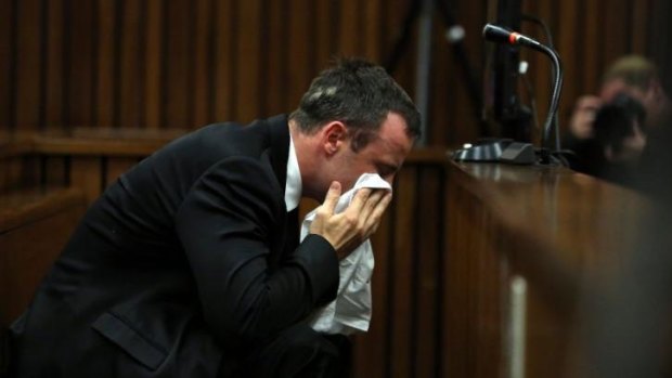 Overwrought: South African Paralympic star Oscar Pistorius wipes his face during his trial in Pretoria.