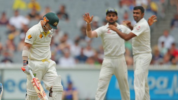 Spray: Indian captain Virat Kohli and Ravi Ashwin celebrate the dismissal of Australian opener David Warner.