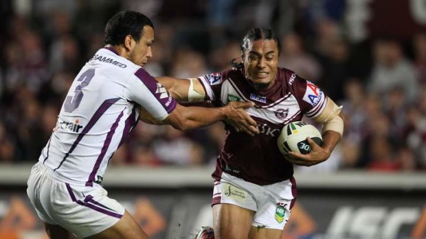 Steve Matai puts a big fend on Will Chambers.