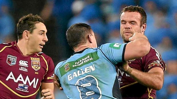 Bringing the biff: Blues skipper Paul Gallen lands one flush on the chin of Maroons forward Nate Myles but remained on the field to lead NSW to victory in game one on Wednesday night.