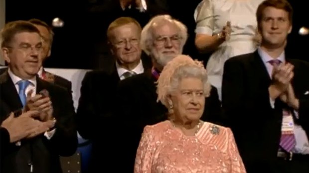 Phil Coates, top right, can be seen slowly ducking to get into the camera shot beside the Queen at the Olympics opening ceremony.