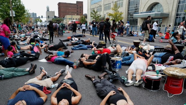 Demonstrators participate in a "die-in" protest outside the St. Louis Police Department headquarters.