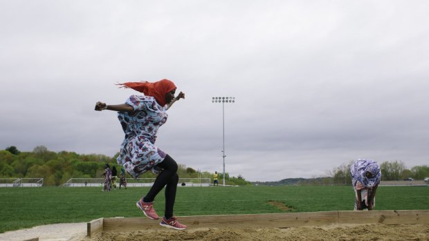 Johorey Abdirahman, left, and Zahara Abdi, members of the Lewiston High School track team, at practice in Lewiston, Maine, in May 2015.