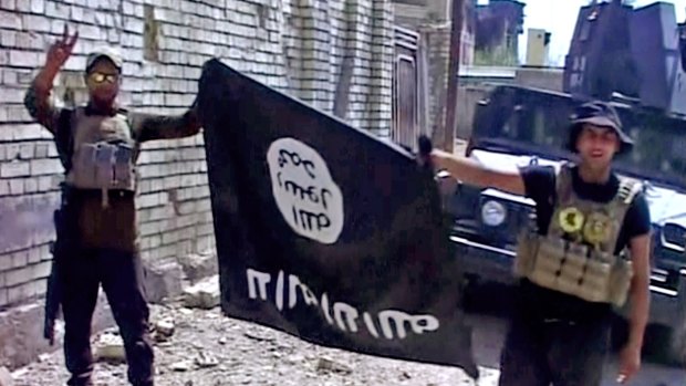 Iraqi troops turn the Islamic State flag upside down after liberating Fallujah from the terrorist group.