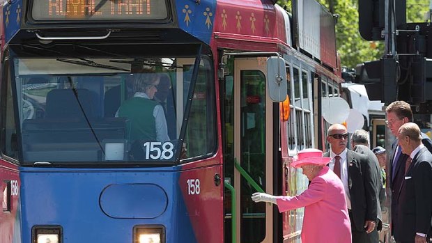 The Queen boards the Royal Tram at Flinders Street yesterday.