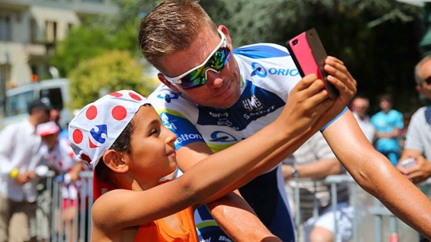 Brett Daniel Lancaster of the Orica-GreenEDGE team has his picture taken by a fan ahead of stage three of the 2013 Tour.