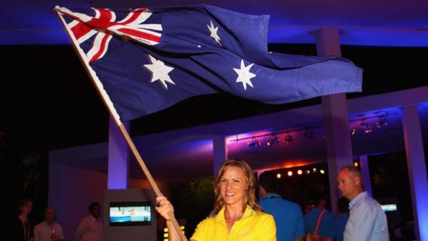 Australian netball team captain Sharelle McMahon waves the Australian flag after her announcement as the opening ceremony flag bearer for the Australian team.
