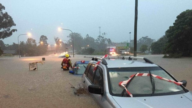 A car under water during severe weather in SEQ on Friday.