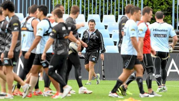 Eye of the storm: The Cronulla players are fiercely loyal to coach Shane Flanagan (centre, back).