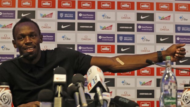 Nothing to hide: Bolt shows a plaster from a doping test during a press conference.