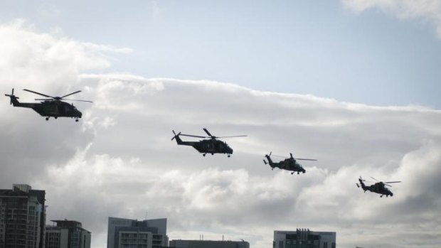 Army choppers fly in formation over the Brisbane CBD, rehearsing their Riverfire show.