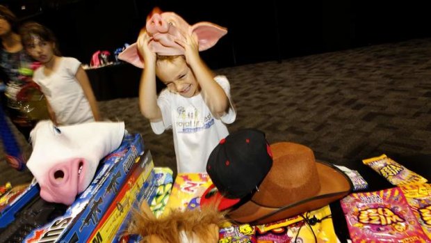 Ryan Mackandev, aged 7, tries out showbags during a Royal Easter Show preview.