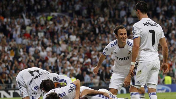 Piling it on ... Real Madrid players celebrate another goal in their 4-0 win over Tottenham.