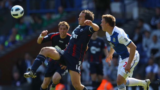 Kevin Davies of the Wanderers holds the ball up under pressure from the Rovers' Phil Jones.