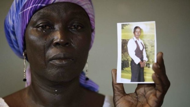 Missing: Martha Mark with a picture of her daughter Monica, one of the 276 girls abducted by Boko Haram in mid-April.