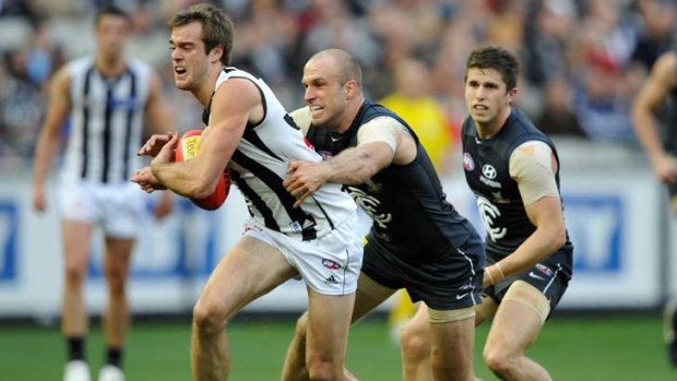Caught: Chris Judd runs down Alan Toovey just the way the Blues may be about to catch up to the Pies.