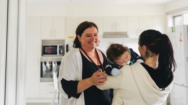 The new Karinya House for vulnerable mothers and babies was officially opened in Belconnen on Wednesday. Case worker Catherine O'Halloran is pictured here with a 20-year-old resident and her three-month-old son.

