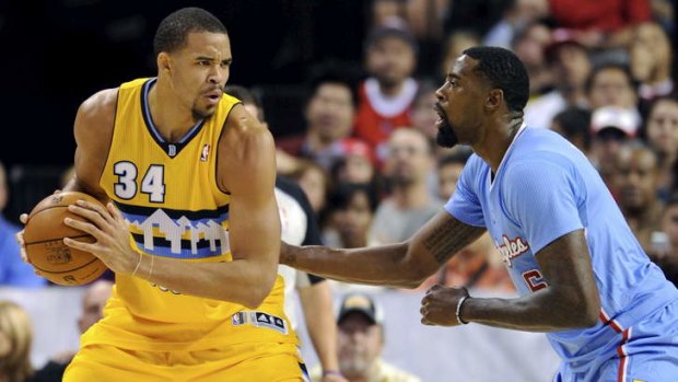 Denver Nuggets centre JaVale McGee is guarded by LA Clippers rival DeAndre Jordan during the preseason.