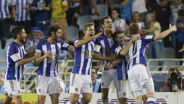 Real Sociedad players celebrate a goal.