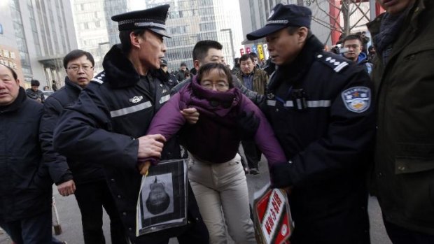 Protest: A supporter of Xu Zhiyong is detained by policemen near the court.
