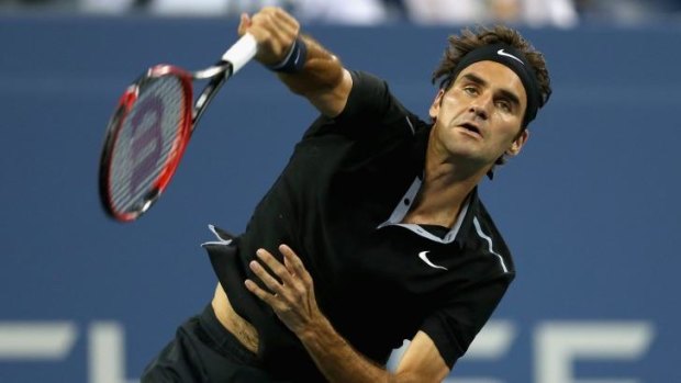 Roger Federer serves during his fourth-round clash with Roberto Bautista Agut.
