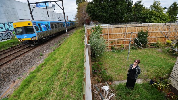 Michelle Clarke in the backyard of her Carnegie home which backs on to the rail tracks where the sky rail will be built.