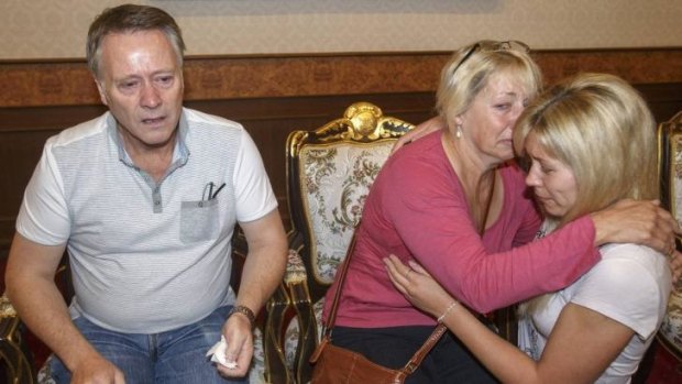 Grieving: Hannah Witheridge's family at the headquarters of the Royal Thai Police in Bangkok.