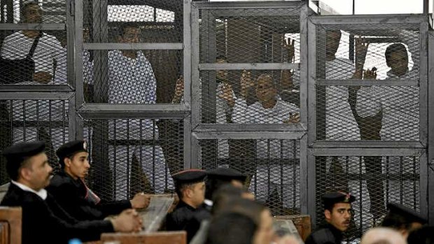 Australian journalist Peter Greste, third from right, of Al-Jazeera and his colleagues inside the defendants' cage during their trial in Cairo.