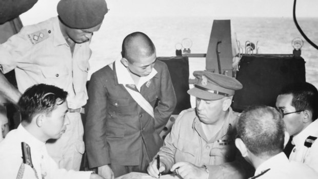 Sir Vernon Sturdee (seated) signs the surrender.