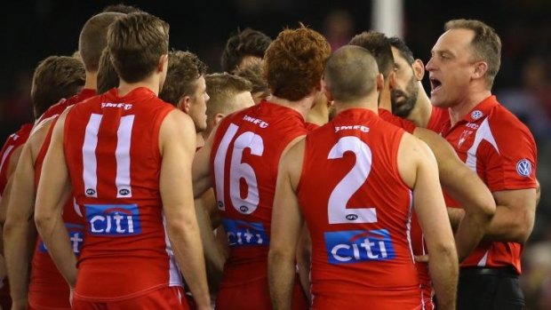 Listen to me: John Longmire talks to the Sydney players during Sunday's game.