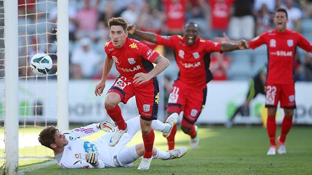 Evan Kostopoulos of Adelaide gets the ball past Nathan Coe of Melbourne Victory to score one of his team's four goals during the round 10 A-League match on December 7 last year. The game attracted almost $50 million in bets from Asian gamblers.