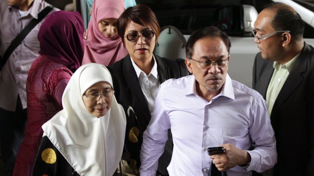 Malaysia's opposition leader Anwar Ibrahim, second right, arrives with his wife Wan Azizah, for the verdict in his final appeal against a conviction for sodomy, at the federal court in Putrajaya in 2015. 