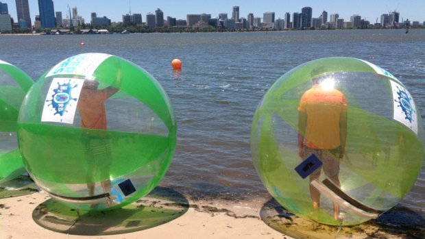 Shaun McManus and Andrew Embley get ready to tackle the strong wind in a race in aquatic zorb balls on the Swan River promoting the Swim the Swan, a part of the BHP Billiton Auqatic Super Series.