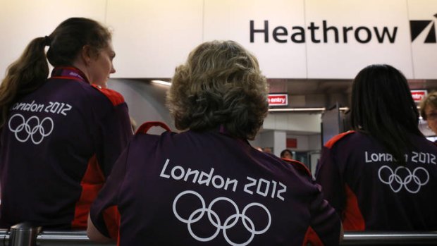 Olympic volunteers wait to greet arriving teams at Heathrow Airport.