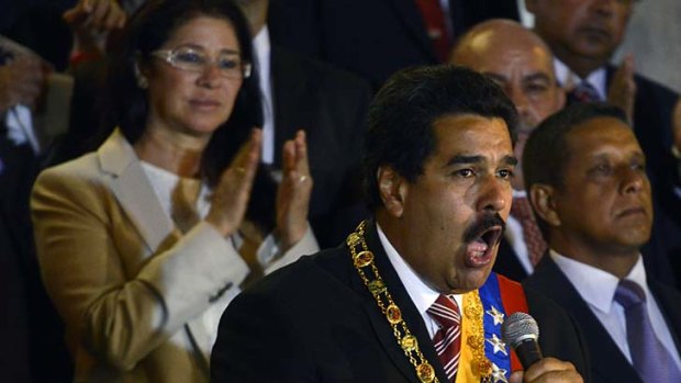 Acting President: Nicolas Maduro is applauded by partner Cilia Flores.
