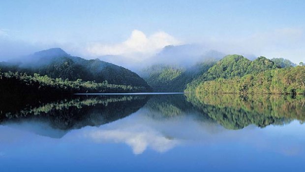 Still waters... the Gordon River provides for a fluid landing between mountains.