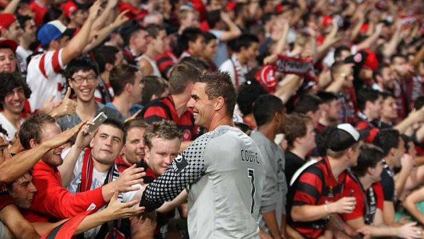 Culture club ... Ante Covic celebrates with fans after the Wanderers 6-1 thrashing of Adelaide.
