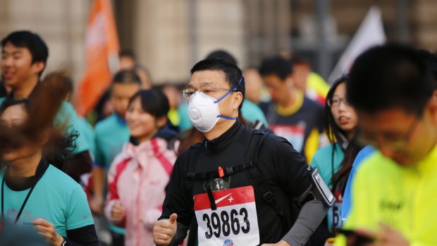 A participant wears a face mask as he competes in the Shanghai International Marathon. The US consulate stated that the air quality readings on the day were "very unhealthy". 