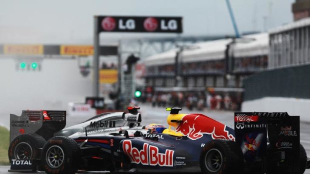 McLaren driver Lewis Hamilton (left) watches as Red Bull's Mark Webber spins in front of him during the Canadian Grand Prix.